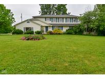 Charming two-story home features a well-manicured lawn and beautiful landscaping at 5135 Moller Rd, Indianapolis, IN 46254