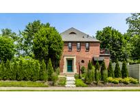 Charming brick home with a well-manicured lawn and stone walkway leading to a green front door at 5401 N New Jersey St, Indianapolis, IN 46220