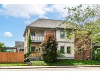 Charming two-story home with a fenced yard and inviting front porch at 635 E 10Th St, Indianapolis, IN 46202