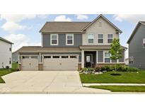 Charming two-story home with a well-maintained lawn, inviting curb appeal, and an attached two car garage at 11588 Brooks Farm Blvd, Noblesville, IN 46060