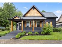 Charming home featuring natural wood accents, neat landscaping, and a covered front porch, perfect for relaxed outdoor living at 117 N Market St, Thorntown, IN 46071