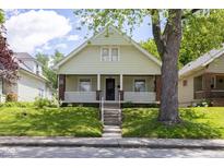 Charming home with a welcoming front porch and mature trees, perfect for relaxing outdoors at 1311 N Oakland Ave, Indianapolis, IN 46201