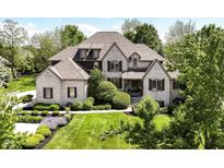 Charming brick home with a lush green lawn and mature landscaping, offering great curb appeal at 13909 Waterway Blvd, Fishers, IN 46040