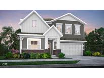 Beautiful new construction home with two-car garage and welcoming front porch with brick and siding at 1725 Hemlock Cir, Greenfield, IN 46140