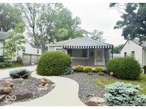Charming home featuring an inviting walkway, awning, and well-maintained landscaping at 1844 N Riley Ave, Indianapolis, IN 46218