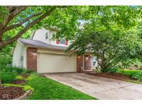 Charming two-story home with a brick facade, attached two-car garage, and mature landscaping at 19061 Fairfield Blvd, Noblesville, IN 46060