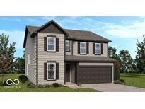 Charming two-story home featuring a two-car garage, complemented by well-maintained landscaping at 1914 White Oak Dr, Shelbyville, IN 46176
