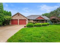 Charming brick ranch home with attached two-car garage and well-manicured lawn at 2027 Round Barn Ct, Anderson, IN 46017