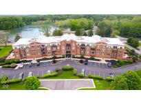 Beautiful aerial view of condo building near a lake with parking and green space at 20971 Shoreline Ct # 201, Noblesville, IN 46062