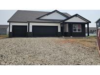 New construction home with a three car garage and modern black and white design at 2339 Pine Valley Dr, Plainfield, IN 46168