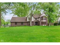 Charming two-story brick home featuring a large, lush green lawn and mature trees at 246 Westchester Blvd, Noblesville, IN 46062