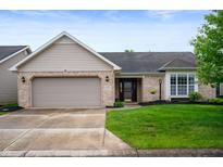 Charming single-Gathering home featuring a brick facade, attached garage, and well-manicured lawn at 2717 W Long Meadow Ln, Muncie, IN 47304