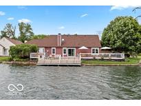 The back of the house has a large yard with a pier and easy access to the lake at 3403 Island Way, Indianapolis, IN 46214