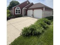 Charming single Gathering home featuring a 2 car garage, landscaped front yard, and red exterior at 3403 Island Way, Indianapolis, IN 46214