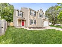 Charming two-story home with a red front door, attached garage, and well-maintained lawn at 3803 Churchman Woods Blvd, Indianapolis, IN 46203