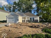 Charming single-story home with a two-car garage, stone accents and a well-maintained lawn in a quiet neighborhood at 3805 Windstar Way, Columbus, IN 47203