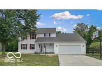 Charming two-story home with red shutters, a well-manicured lawn, and an attached two-car garage at 3916 Jekyll Ct, Indianapolis, IN 46237