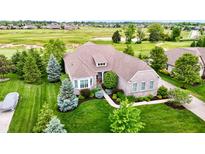 Beautiful single-Gathering home featuring a well-manicured lawn and lush landscaping at 4420 Hickory Ridge Blvd, Greenwood, IN 46143