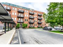 Charming brick apartment building featuring balconies, designated parking and lush green landscaping at 55 S Harding St # 308, Indianapolis, IN 46222