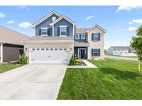 Beautiful two-story home with brick and siding exterior and well-manicured front lawn at 5848 Sheffield Ln, Whitestown, IN 46075