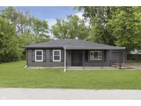 Charming single-story home with a well-manicured lawn and gray siding at 625 E 106Th St, Carmel, IN 46280