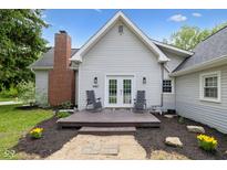 Charming home featuring a brick chimney, a cozy deck with seating, and a well-maintained yard at 6450 N State Road 75, North Salem, IN 46165