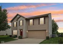 Charming two-story home with a brick and vinyl exterior and a two-car attached garage at 764 Port Dr, Avon, IN 46123