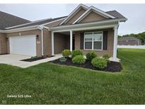 Charming single-story brick home with manicured lawn, covered entry, and attached garage at 9106 Hedley E Way, Avon, IN 46123