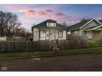 Charming home featuring a fenced yard, neutral paint and inviting curb appeal at 1216 N Ewing St, Indianapolis, IN 46201
