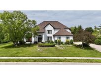 Charming two-story home with a lush green lawn, mature trees, and a welcoming front entrance at 14020 Brookstone Dr, Carmel, IN 46032