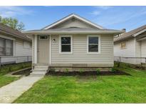 Charming home featuring fresh landscaping and a well-maintained yard at 1606 Asbury St, Indianapolis, IN 46203