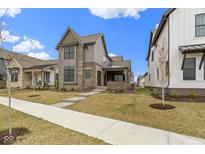 Beautiful home with a covered porch, modern siding, and professionally landscaped front yard and walkway at 17359 Wilkes Way, Westfield, IN 46074