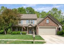 Charming two-story home with brick accents, attached garage and well-manicured lawn at 18278 Benton Oak Dr, Noblesville, IN 46062