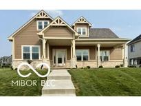 Charming home with a covered front porch and beautifully landscaped front yard at 217 N Liberty Blvd, Mooresville, IN 46158