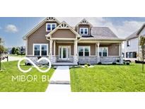 Charming home featuring a welcoming front porch, complemented by well-maintained landscaping and an inviting exterior at 217 N Liberty Blvd, Mooresville, IN 46158