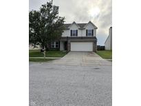 Traditional two-story home with a well-manicured lawn, two-car garage, and basketball hoop in the driveway at 2730 Foxbriar Pl, Indianapolis, IN 46203