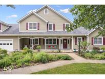 Charming two-story home with a well-manicured lawn, lovely garden, and inviting front porch at 2971 N Buck Creek Rd, Greenfield, IN 46140