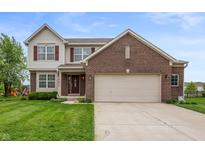 Inviting two-story home featuring a brick facade, attached two-car garage, and well-manicured lawn at 3638 Fieldstone Ln, Plainfield, IN 46168