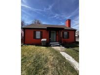 Charming orange single-story home featuring a welcoming front porch and well-maintained front yard at 3752 N Oxford St, Indianapolis, IN 46218