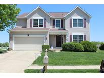 Charming two-story home with attached garage, well-manicured lawn, and inviting curb appeal at 5101 W Bay Rd, Plainfield, IN 46168