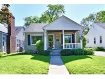 Charming single-Gathering home with stone accents, covered porch, and well-manicured lawn at 6187 Crittenden Ave, Indianapolis, IN 46220