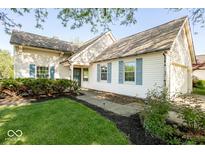 Charming home featuring blue shutters, a well-maintained lawn, and landscaped garden beds at 7650 Micawber Ct, Indianapolis, IN 46256