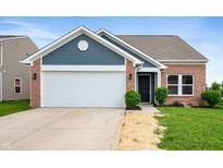 Charming single-story brick home with a two-car garage and manicured front lawn at 7918 Wolfgang Pl, Indianapolis, IN 46239