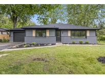 Charming grey ranch home with black trim, attached garage, and a nicely landscaped front yard at 8933 W 1050 S, Fortville, IN 46040