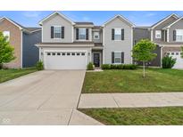 Two-story home with gray siding, black shutters, a two car garage and a well manicured front yard at 918 Cass Dr, Franklin, IN 46131