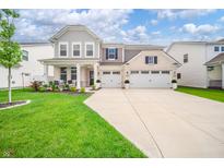 Inviting two-story home featuring a manicured lawn and a spacious three-car garage at 9369 Casey Rd, Pendleton, IN 46064