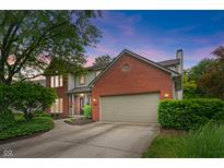 Charming two-story home featuring a brick facade, attached garage, and beautifully landscaped front yard at 10501 Greenway Dr, Fishers, IN 46037