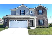 Charming two-story home featuring a brick and vinyl facade, attached garage, and well-maintained landscaping at 1056 Bent Branch Ln, Greenwood, IN 46143