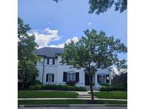 Charming white two-story home with black shutters, mature trees, and manicured landscaping at 12437 Meeting House Rd, Carmel, IN 46032