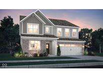 Charming two-story home featuring a brick and siding exterior with a two-car garage and well-manicured landscaping at 19843 Moorpark Lndg, Noblesville, IN 46062